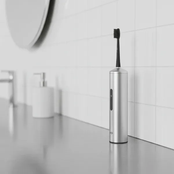 Sleek Quip electric toothbrush with its travel case, minimalist design on a modern bathroom counter.